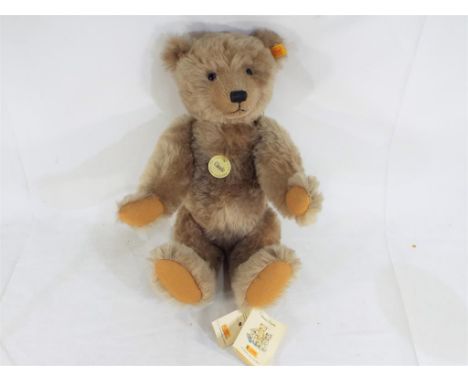 A Steiff mohair Growler Bear from the Classic Series, with stitched nose and jointed limbs, (No 004612) attached tags, yellow