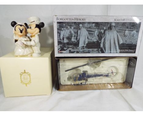 Corgi - a Forgotten Heroes 1.48 scale diecast model H13 Bell Helicopter by Corgi # US51902 and a ceramic Disney Showcase figu