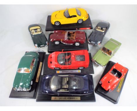 Eight unboxed large scale diecast model motor vehicles comprising Maisto, Burago, Hot Wheels and Mini Champs, appear to be in