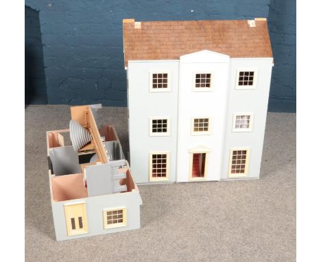 A large wooden doll house fitted with interior lighting and furniture contents.  