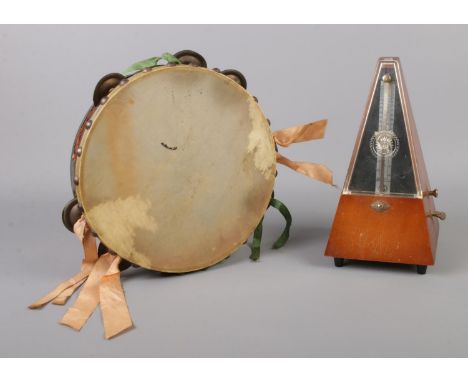 A vintage SX metronome, together with hide fronted tambourine.  