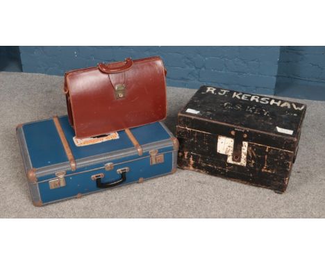 A small painted wooden tool chest along with a vintage suitcase and briefcase.  