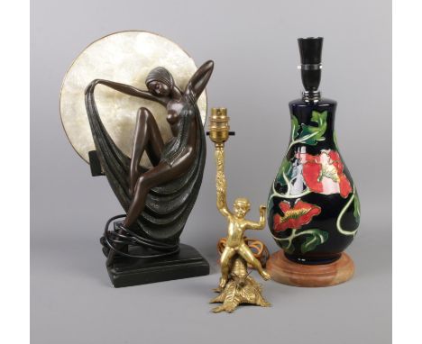 A trio of table lamps including Art Deco style woman in drapery and black floral ceramic lamp.  