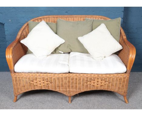 A cane and rattan conservatory suite. Comprising of a two seat sofa, armchair and coffee table. Sofa H: 87cm W:140cm D:61cm. 