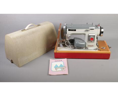 A Jones Model 568 sewing machine with case, instruction manual and assorted accessories.  