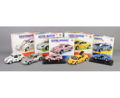 A collection of five boxed Burago metal kit scale models. To include 2002 Aston Martin Vanquish (1/18) and 1991 Bugatti Le Ma