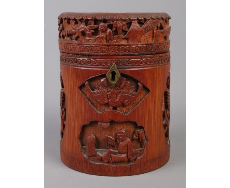 A Japanese bamboo tea caddy of cylindrical form, with carved scenes. 16cm high.  Hinge missing.