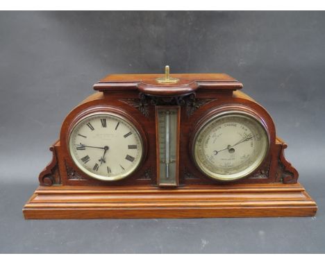 An early 20th Century mahogany clock/barometer/thermometer in ornately carved case, clock dial signed Goldsmith's Co. 112 Reg