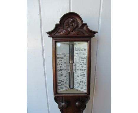 A mid 19th Century moulded and carved mahogany stick barometer, twin ivorine dials with verniers and correct keys, carved and