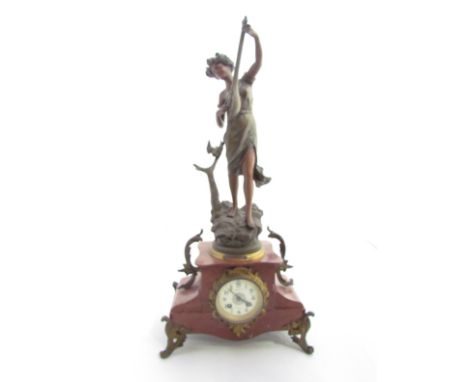 A 19th Century rouge marble and ormolu mantel clock, 25" high surmounted by a spelter figure of female musician