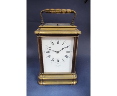 An oversized cornice cased carriage clock, brass case, enamel dial with Roman numerals by J.W. Benson (hairlined), platform e