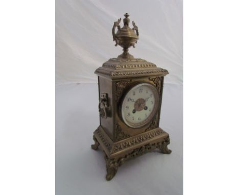 A brass mantel clock, 8-day movement, 16" high with urn finial 