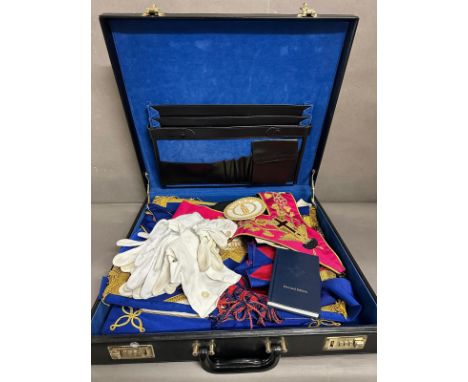 A briefcase containing a selection of Masonic items to include gloves, aprons and medals