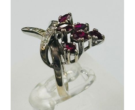 A ruby and diamond crossover ring on white gold setting approximate size L
