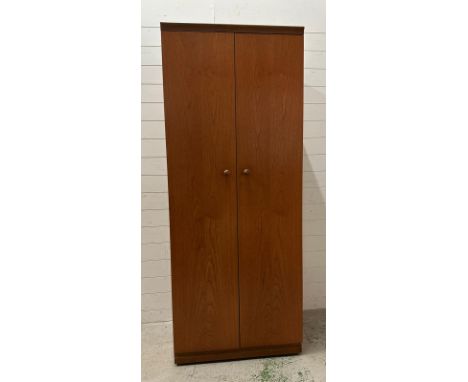 A teak Mid Century two door wardrobe with veneered interior, cross rail and shelf over by Mevedew (H190cm W76cm D54cm)