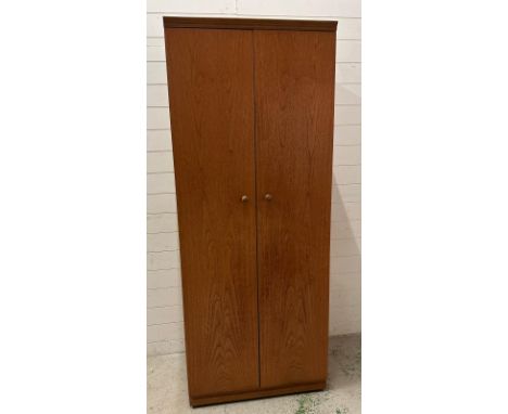 A teak Mid Century two door wardrobe with veneered interior, cross rail and shelf over by Mevedew (H190cm W76cm D54cm)