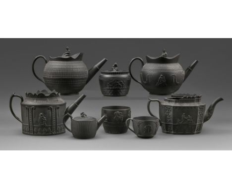 Five engine turned and other black basalt teapots and covers, a sugar box and cover, cache pot and Wedgwood teacup, c1800, co