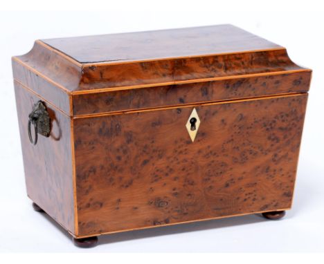 A Victorian inlaid burr walnut sarcophagus shaped tea caddy, with divided interior, ivory escutcheon, twin ring handles and b