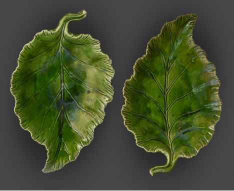 A pair of green glazed leaf shaped earthenware dishes, Staffordshire or Yorkshire, c1810, the stalk forming the handle, on th