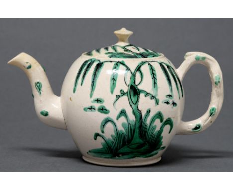 A Staffordshire saltglazed white stoneware teapot and cover, c1760, enamelled in black and green monochrome with weeping tree