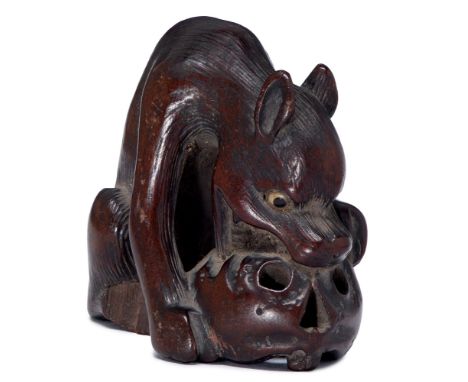 A Japanese wood netsuke of a ravenous wolf, late 18th/19th c, the inlaid bone eyes with horn pupil, old rich dark patina, 40m