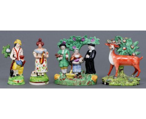 A Staffordshire earthenware figure of a gardener, a figure of a woman holding a lute and a model of a deer before bocage, c18