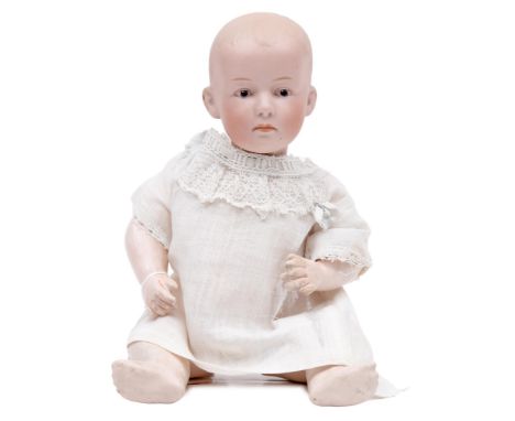 A German bisque head character doll, likely Gebruder Heubach, c1910, bisque head with intaglio eyes, closed mouth and moulded