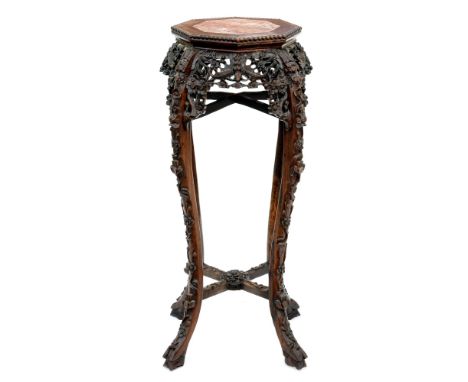 A Chinese carved hardwood jardiniere stand, c1900, with octagonal stone inset top with beaded edge, 91cm h  Complete and in g