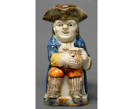 A Prattware toby jug and cover, c1790, of pearlware sponged in a typical palette, the cover original to the jug, 26cm h  Jug 