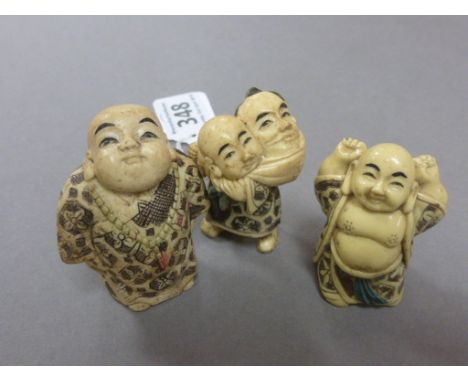 Three netsuke figures including Buddha's