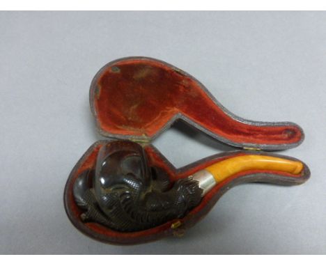 Cased Meerschaum Pipe with carved claw bowl, amber mouth piece and silver collar