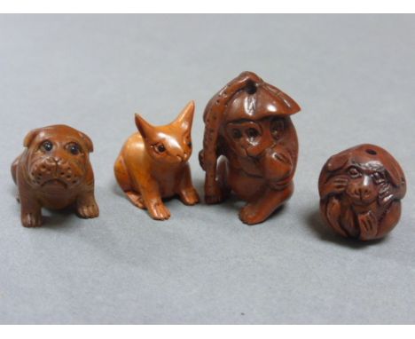 Four wood netsuke carvings including bulldog (signed), rabbit, monkey and another