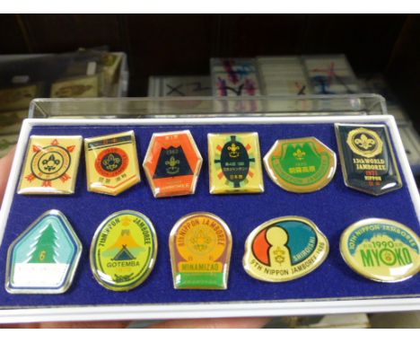 Ten Folders of Scouting and Girl Guide Cloth Badges from around the world plus 11 Enamel Japanese Badges