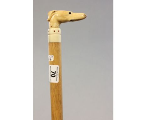 An antique walking stick with carved ivory greyhound handle