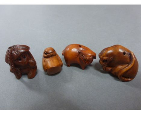 Four wood miniature netsuke carvings of animals including pig (signed), monkey, bird and another signed