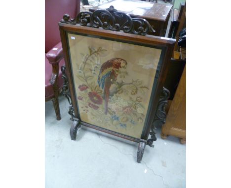 19th century Mahogany Fire Screen with Scroll Carved Panels and a Needlework Panel depicting a Parrot