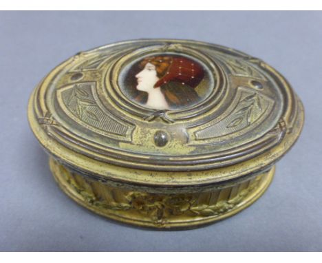 Late 19th / Early 20th century Gilt Metal Oval Box, the hinged lid set with an Enamelled Portrait of a Young Woman, marked to