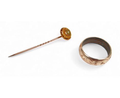 A gilt metal ring, size T, together with a gilt metal tie pin, set with a small white stone, combined weight 6.5g. (2)
