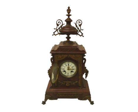 A French 19th century mantel clock, the red marble case decorated with floral swags and surmounted by an urn, the dial signed