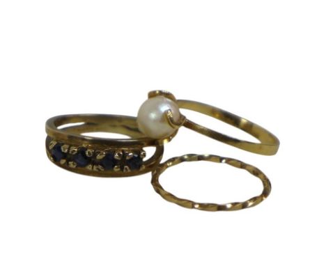 Three yellow gold rings, an 18ct pearl ring size O 1.6g, and two 9ct gold rings size K, total weight 3.4g.(3)