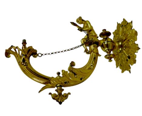 A Victorian bronze gilt wall light fitting with a seated lady holding an oil lamp on an acanthus scroll support, with kite ma