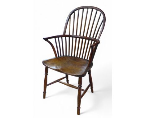 A 19th century yew wood and elm stick back Windsor elbow chair, 57 by 53 by 98cm high.