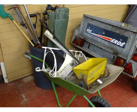 Parcel of long handled garden tools in a plastic bin, metal wheelbarrow etc