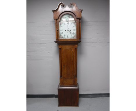 An oak eight day longcase clock with pendulum and weights 