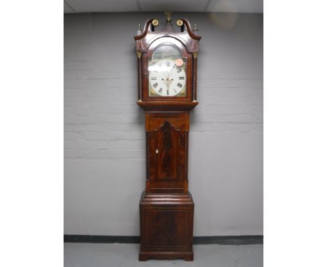 A mahogany eight day longcase clock with painted dial signed Thos. Hill, Barton, with pendulum and weights 