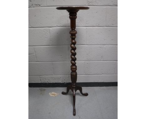 A mahogany barley twist plant stand on tripod base