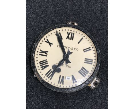 A cast iron cased station clock signed Pulsynetic Electric CONDITION REPORT: 50cm diameter. Iron frame in weathered condition