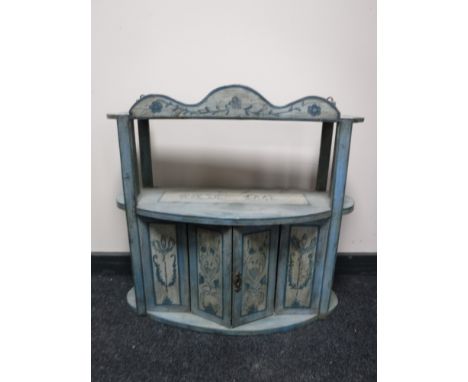 An early 20th century hand painted wall shelf fitted with a cupboard 