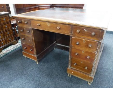 A Victorian mahogany leather topped writing desk fitted nine drawers 