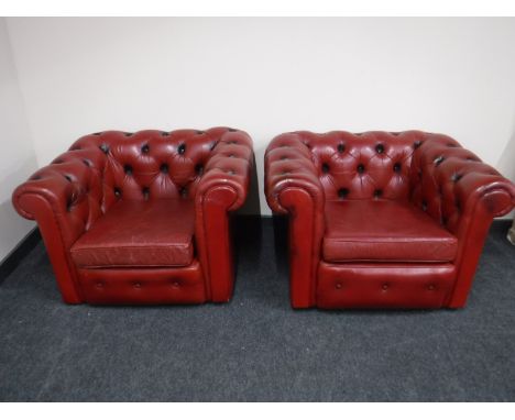 A pair of red button leather Chesterfield armchairs 